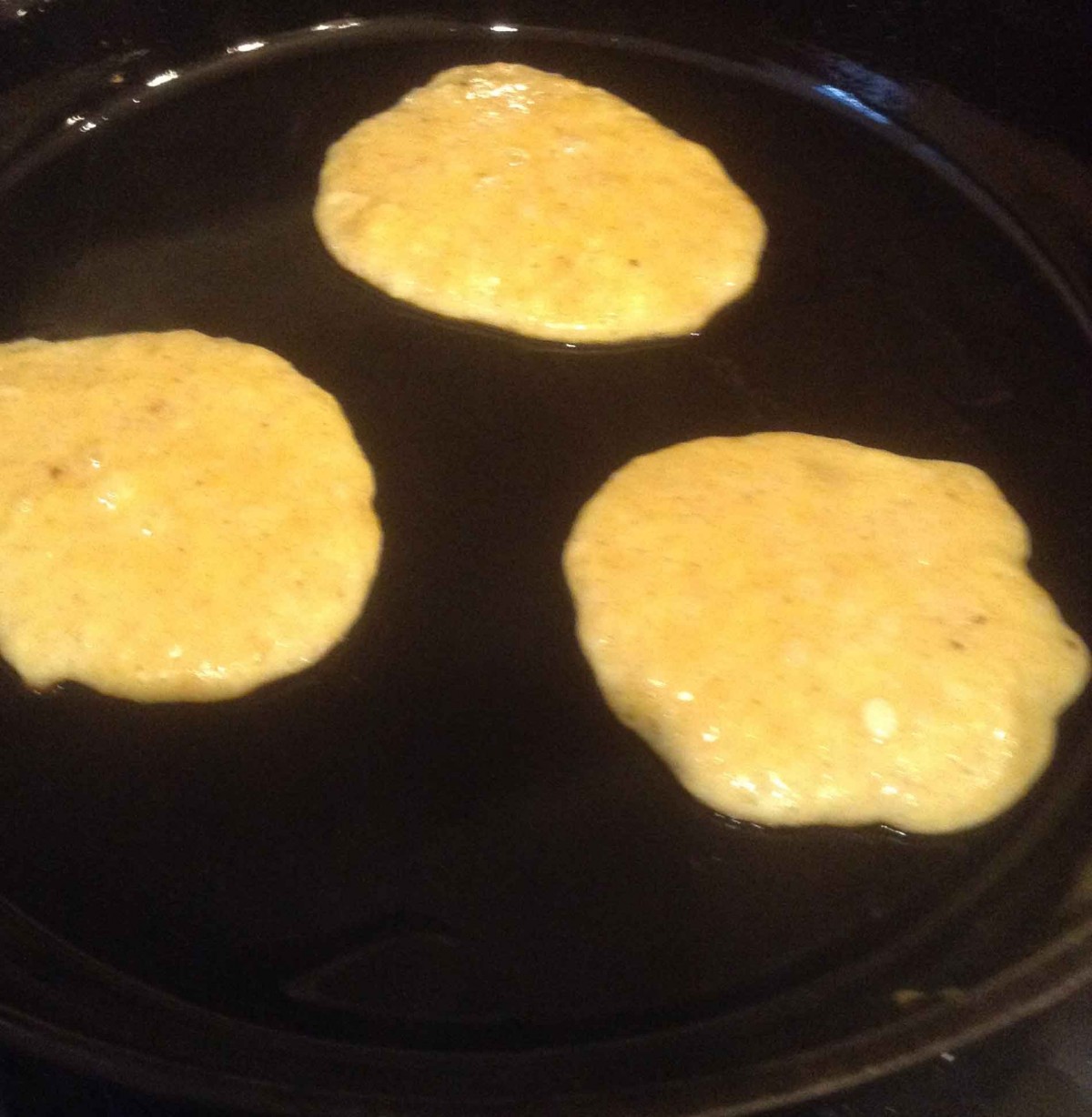 Three pancakes on castiron skillet
